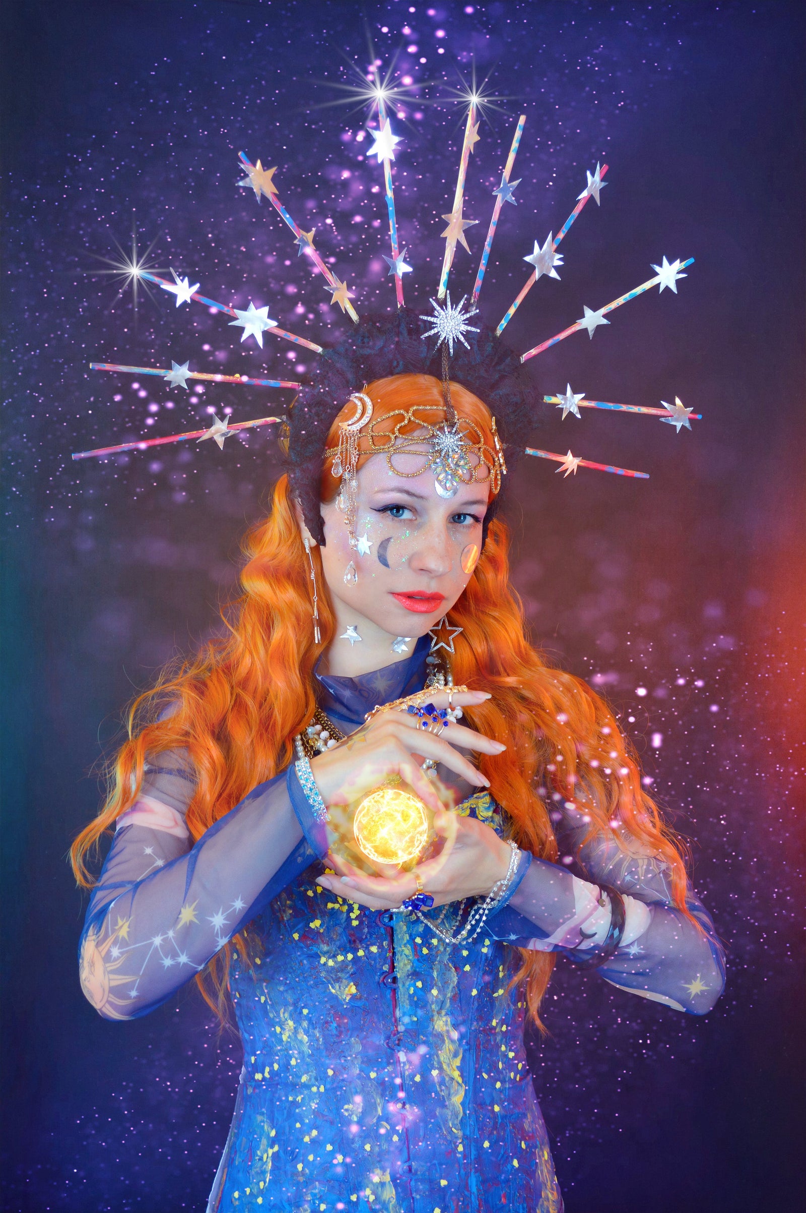 a woman in a blue dress holding a gold ball