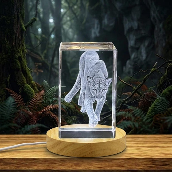 a glass block with a silver bird inside of it