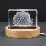 3D engraved crystal cloche hat sculpture in a glass cube